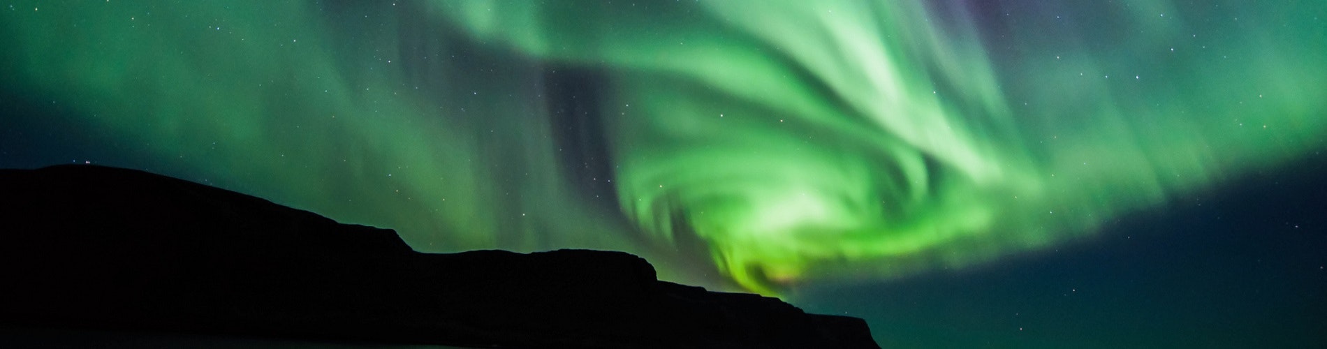 Northern lights over a mountain in Iceland