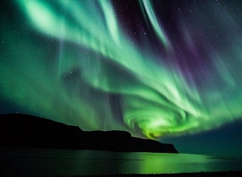 Northern lights over a mountain in Iceland